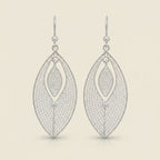Tashra silver filigree leaf drop earrings with a delicate, intricate pattern and a modern, oval shape.